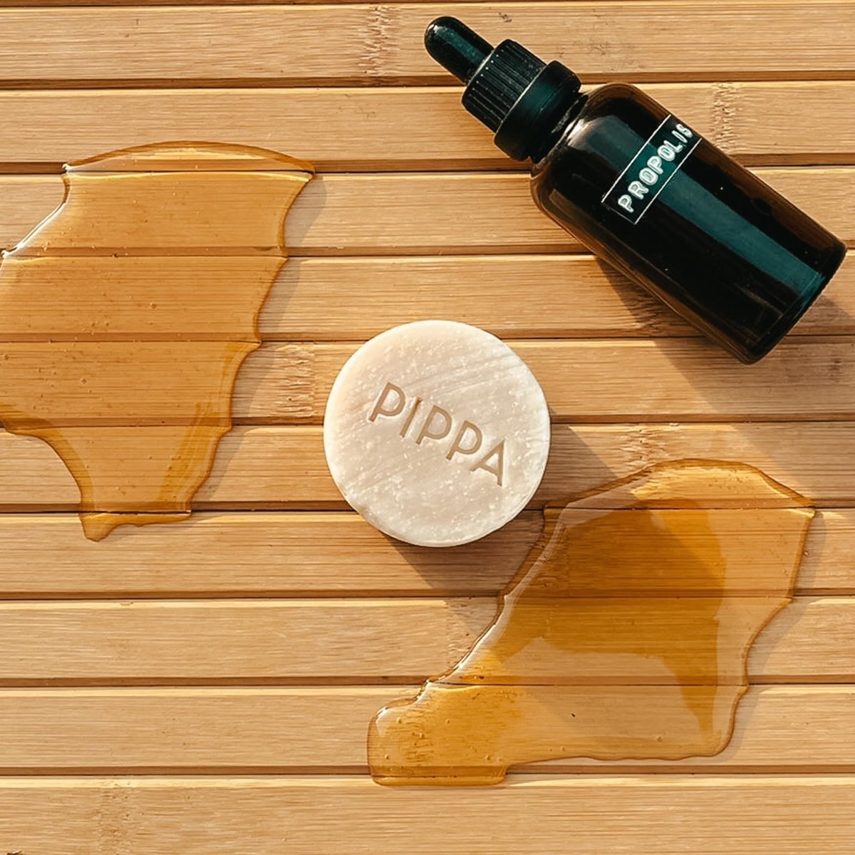 pippa hydraterende body bar honey en propolis op tafel met honing en propolis er omheen
